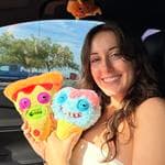 Jules, founder of ThriftyJulez, holding handmade plushies in Yuma, Arizona